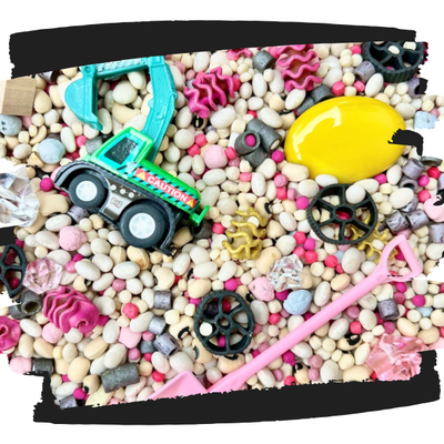Construction chic themed sensory kit for sensory play with pink colored pasta and non-toxic dyed beans mixed sensory filler.