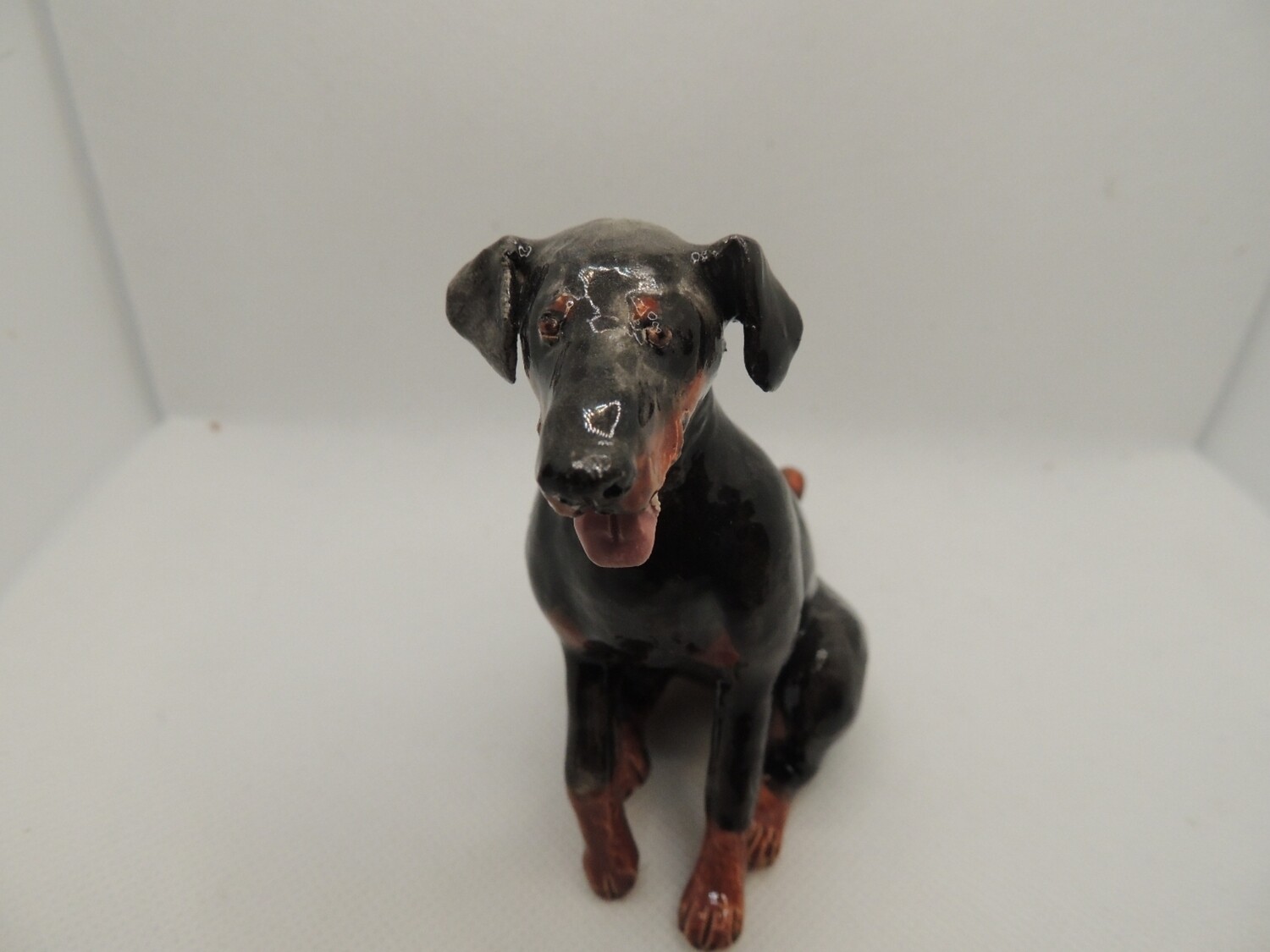 Doberman, black and tan, sitting