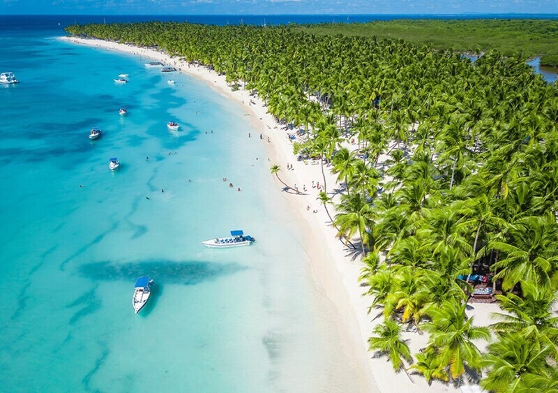 Aerial view of Saona beach with speedboats and turquoise water