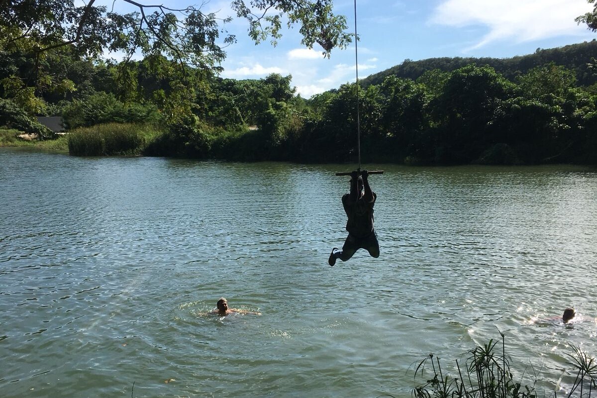 Traveler jumping into the river from the bank during the Safari Buggy