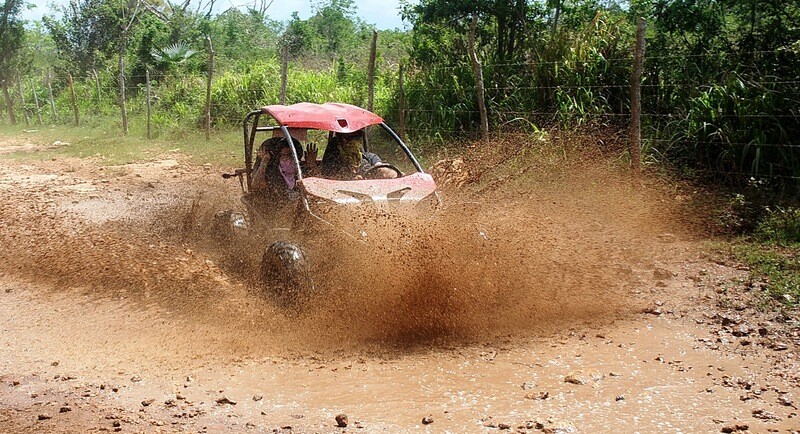 Buggy driving through mud in the Dominican countryside