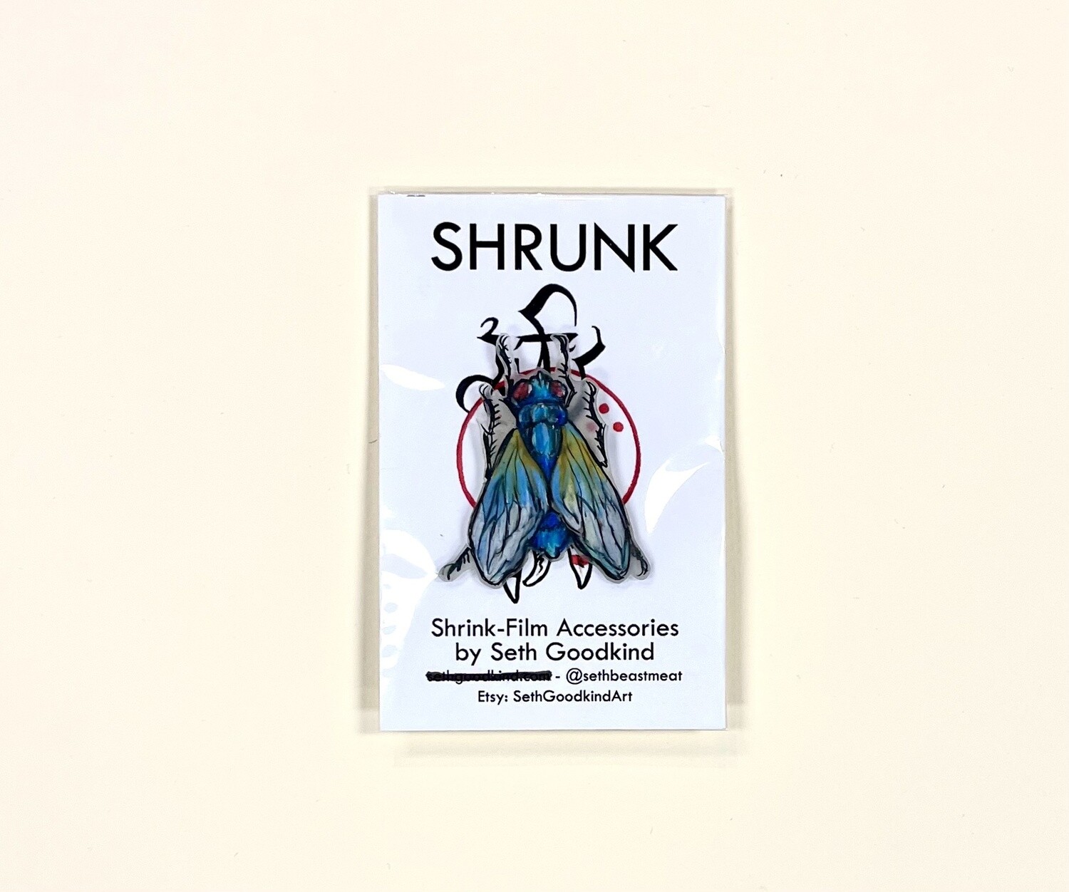 Blue Fly Shrinky Dink pin, by Seth Goodkind