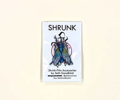 Blue Fly Shrinky Dink pin, by Seth Goodkind