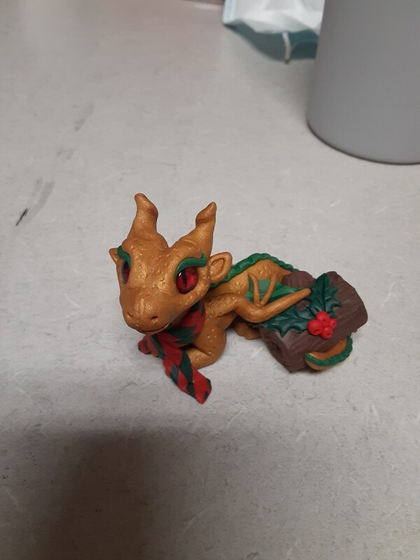 Golden dragon with Yule log