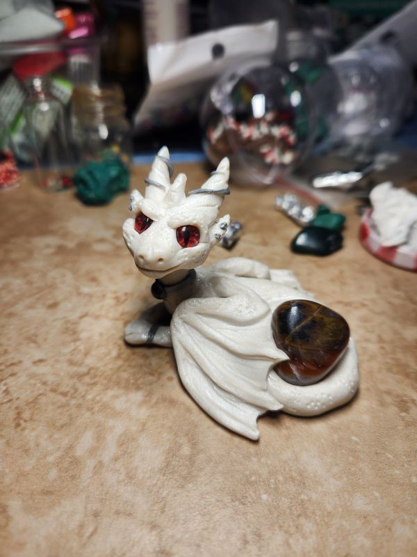 Albino dragon with a stone
