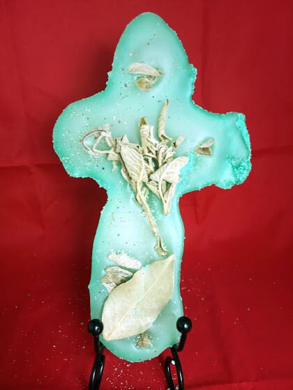 Handmade unique cross, made by sand, wax, and herbs, sage and Laurel.