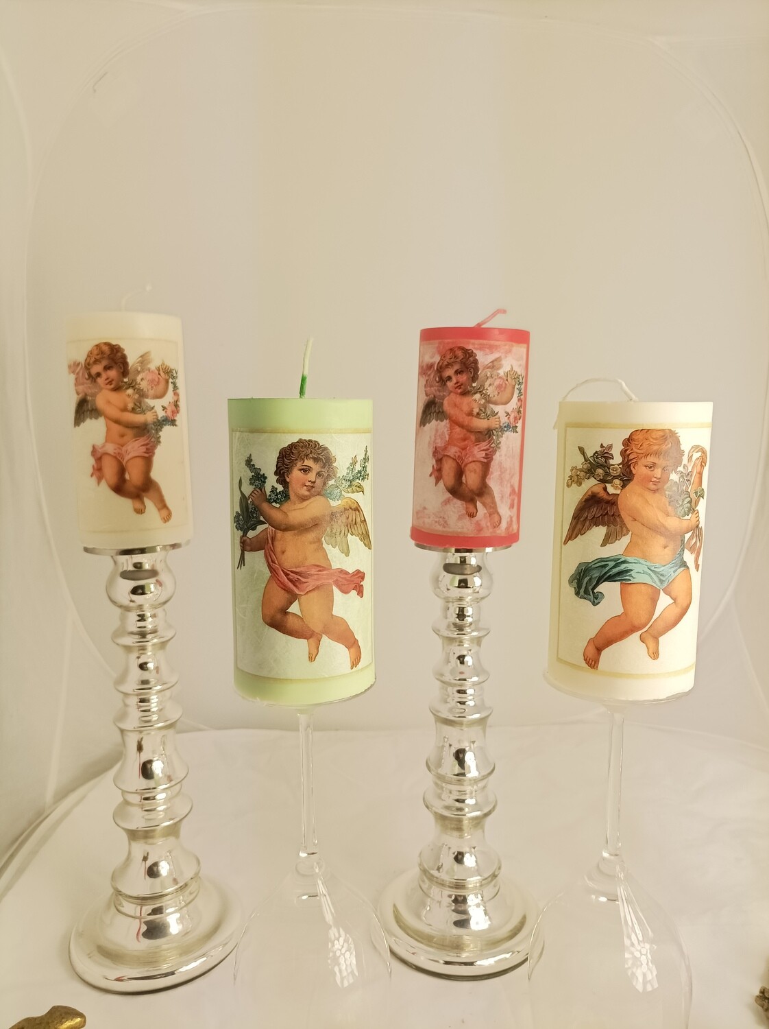 4 candles with different angels