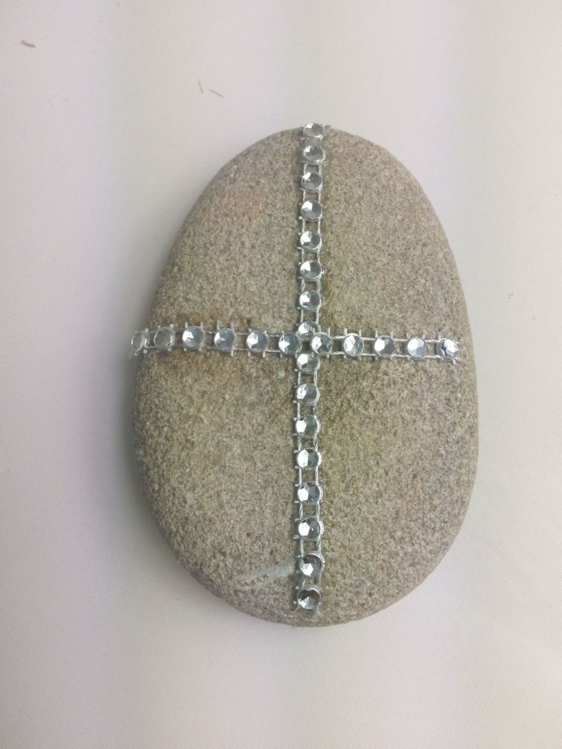 Cross in a big sea stone