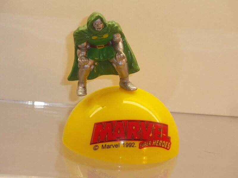 Marvel Super Heroes: 1992: Dr. Doom
Figur auf gelber Halbkugel mit Schriftzug (Figur ist auf Kugel gesteckt)