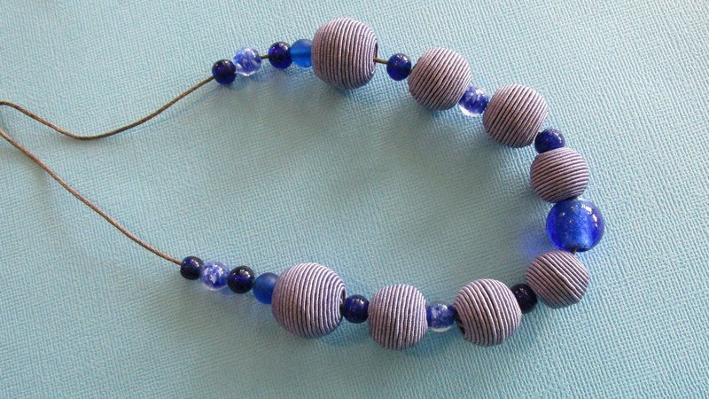 NECKLACES
View All (9), Click to Select: #9 Blue Glass beads with Wrapped Beads on Cord