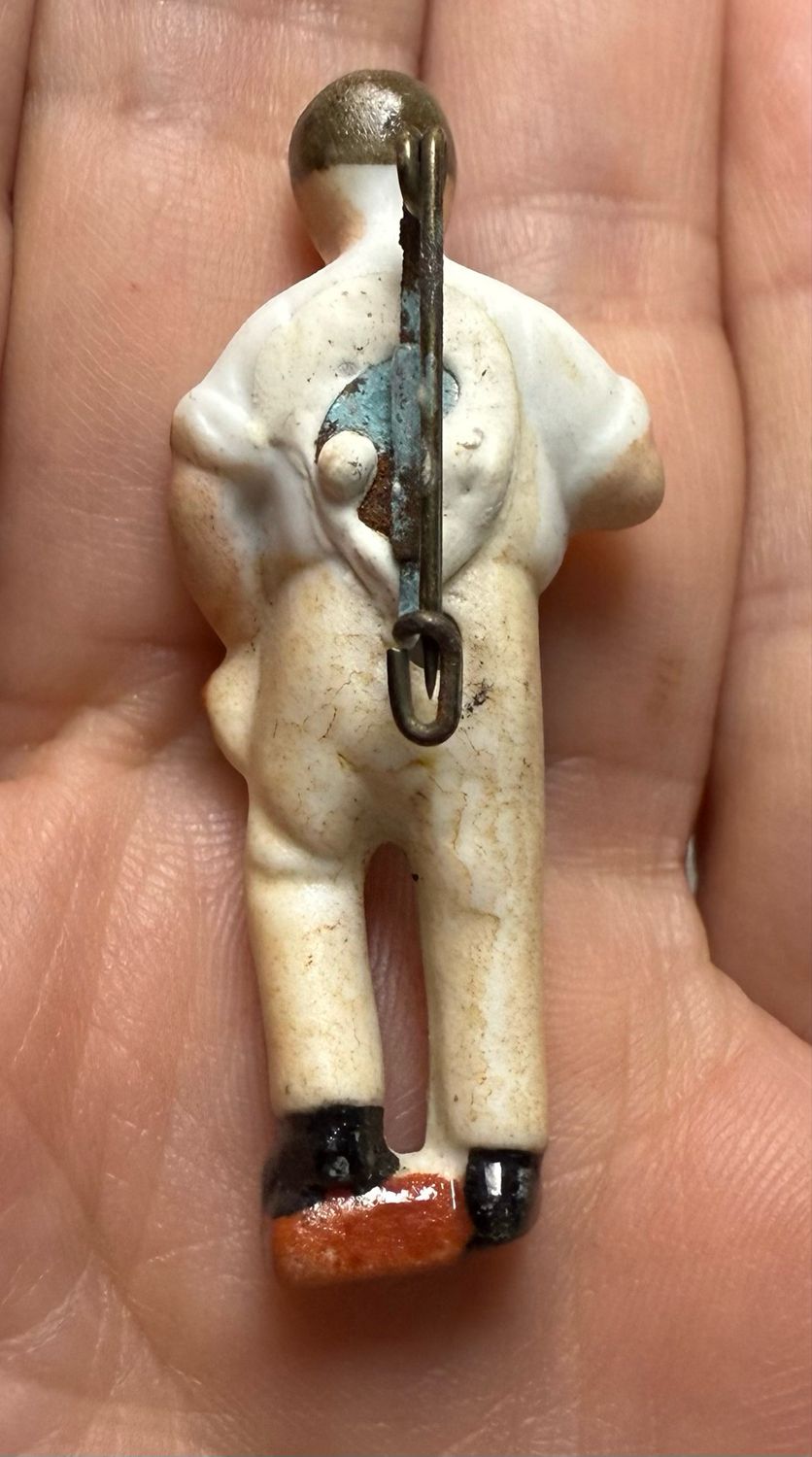 German Third Reich WHW Porcelain Figure Pin of Brick Mason with Brick and Walling Hammer