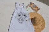 Woman's flowy t back tank with wisdom hand art