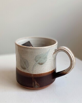 White and Brown Pottery Mug with Blue Leaves