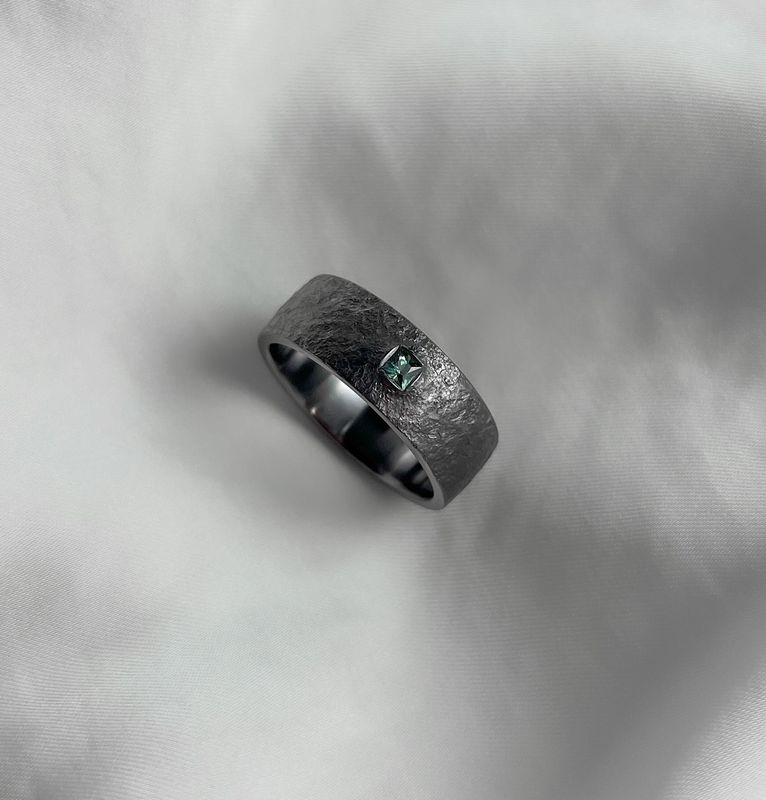 Tantalum Rust Textured 8mm Band, Set with 2.75mm Princess Cut Teal Sapphire Size 9.5+ Tantalum Rust Textured 8mm Band, Set with 2.75mm Princess Cut Teal Sapphire Size 9.5+