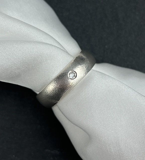 Textured 6mm Band Flush Set with an Antique Cut 2.3mm Natural Diamond Size 10