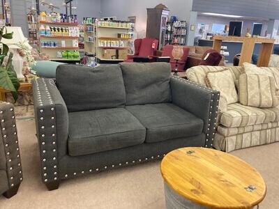 Gray loveseat with silver brads