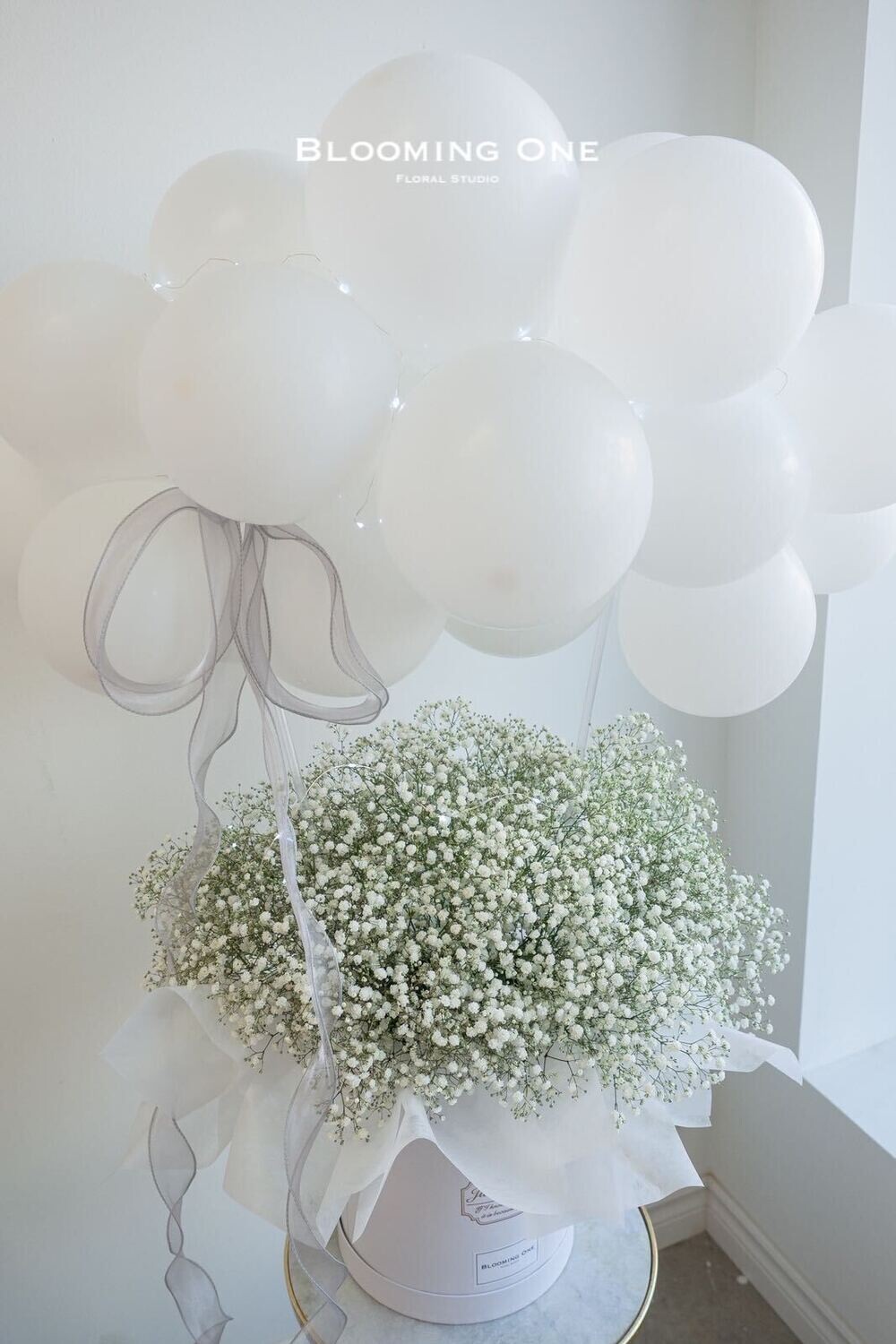 Baby's breath in a box with balloon