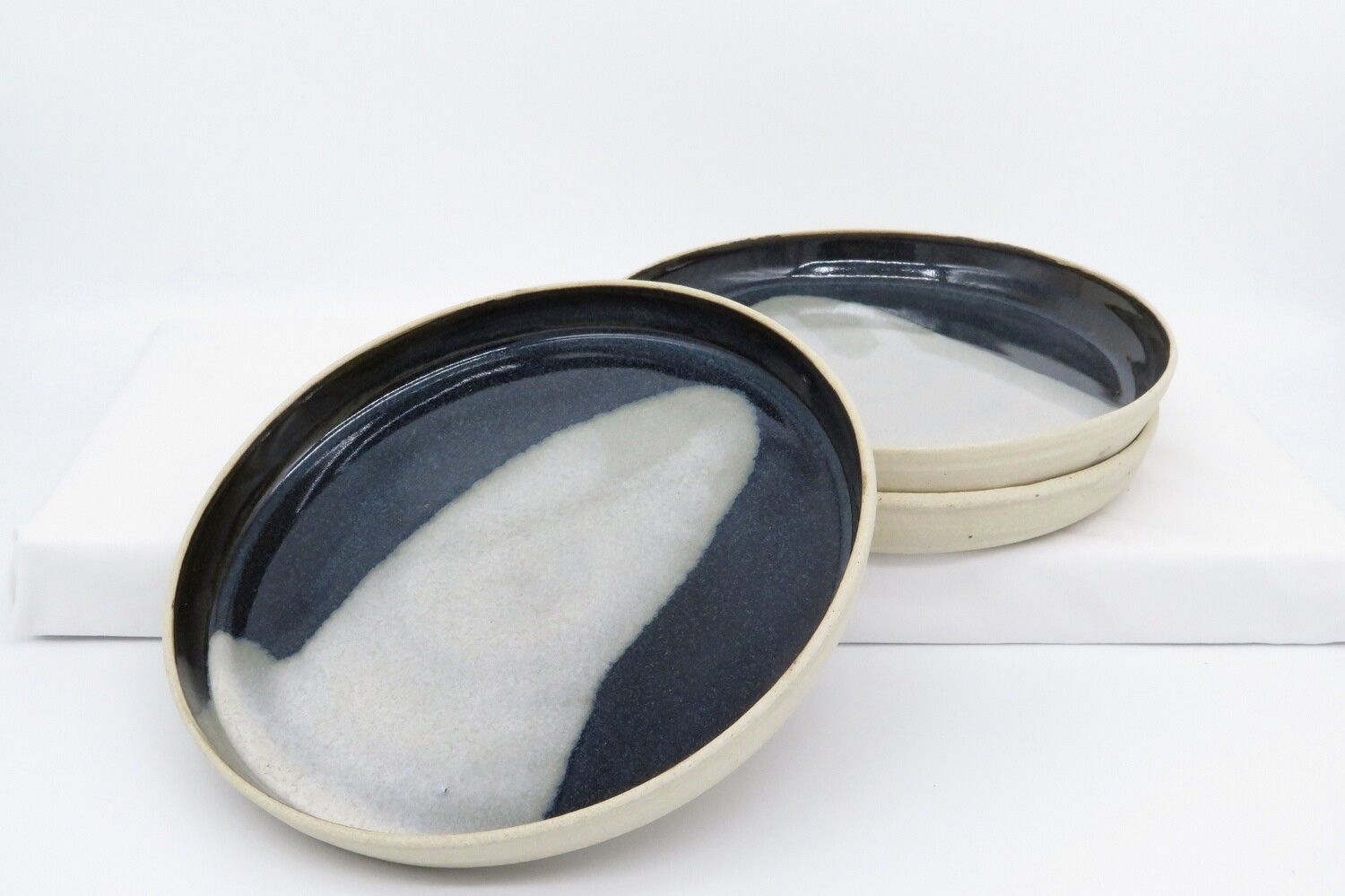 Side Plate - Black and mottled grey.