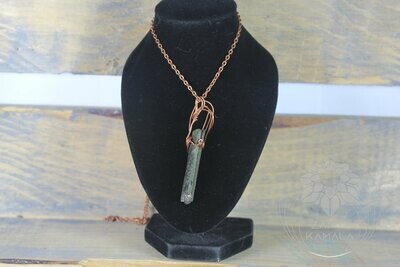 Epidote in hand wrapped in copper necklace