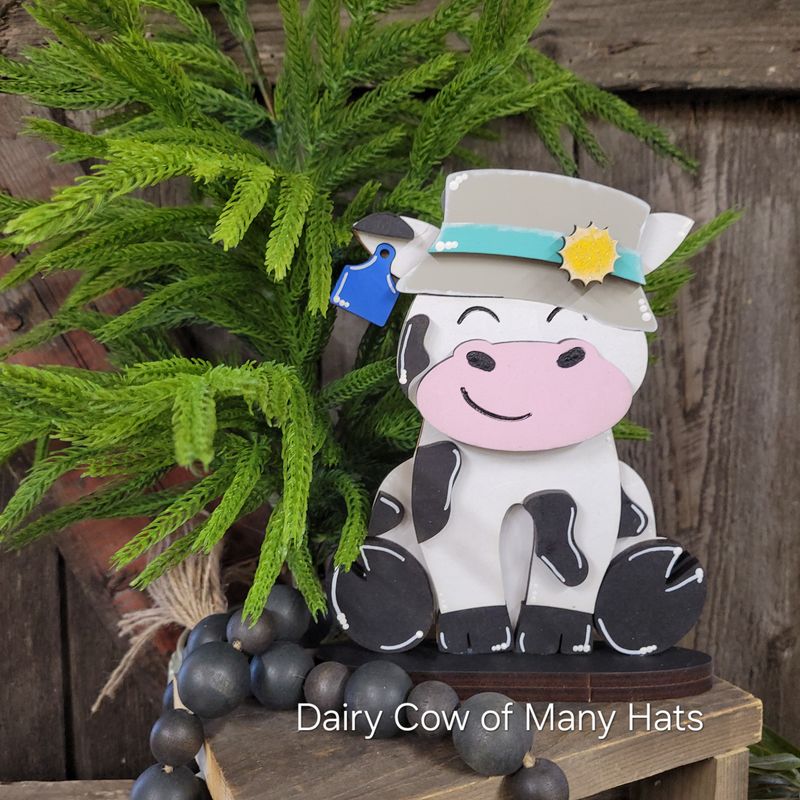 DAIRY COW OF MANY HATS