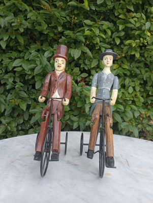 Nice couple of cyclists on authentic bicycles from the past