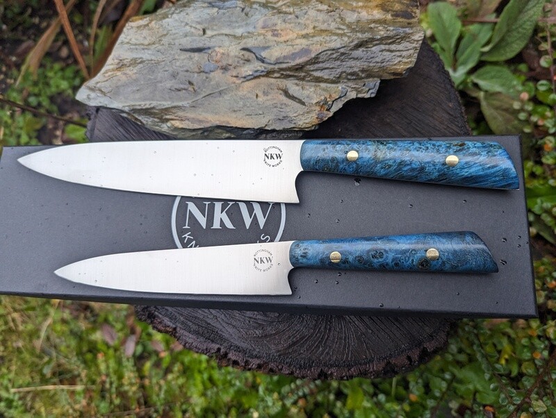 Two piece knife set.
One Handmade 8" chef's knife and one handmade everyday kitchen knife, SF100 stainless steel and blue Boxelder burl handle