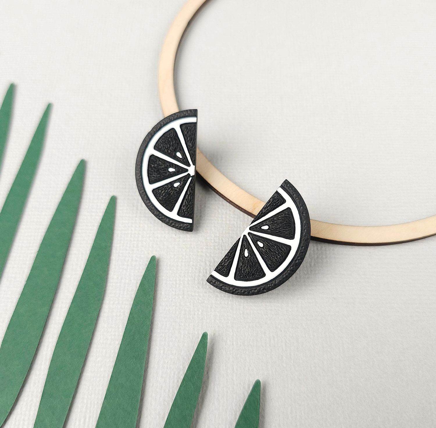 A pair of black and white citrus slice earrings