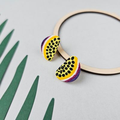 A vibrant pair of passion fruit-shaped earrings. 
