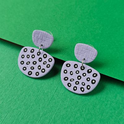 A pair of purple earrings with a geometric design.