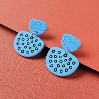 Pale blue earrings with a textured top section and a larger lower, rounded shape below.