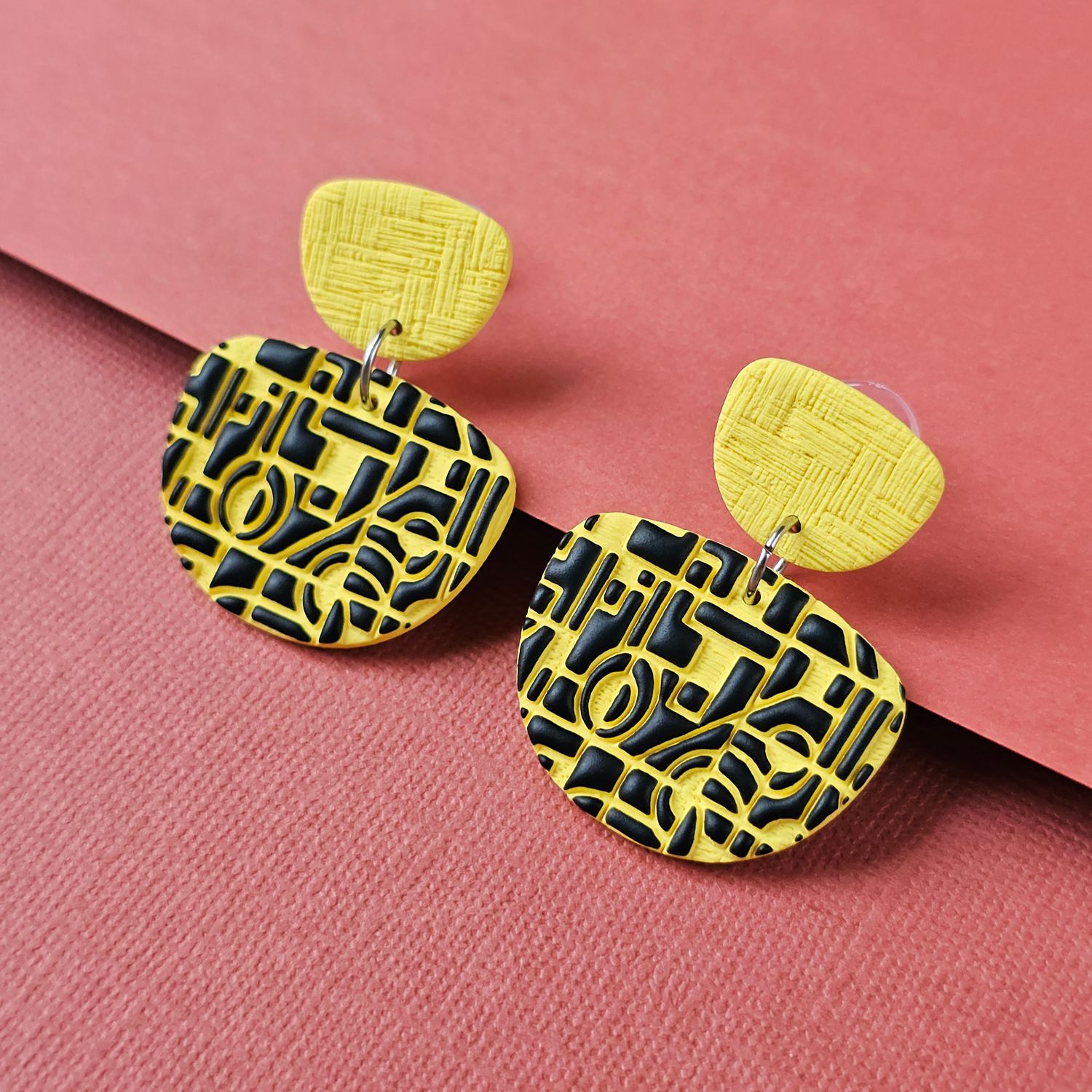 A pair of yellow and black geometric earrings