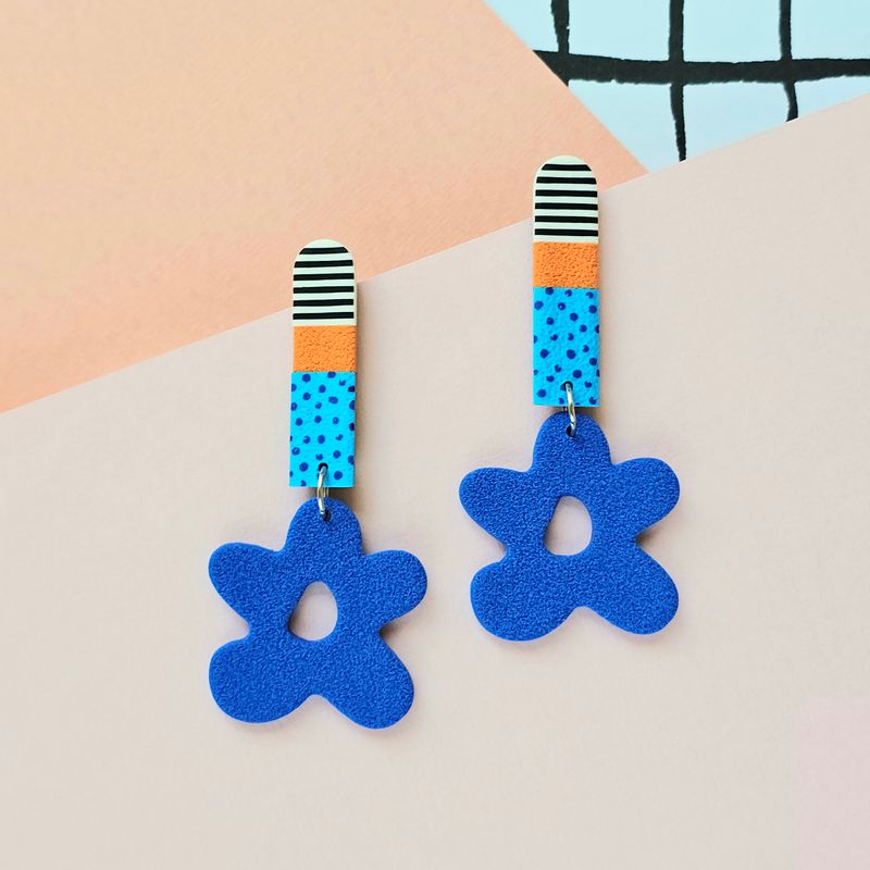 Long statement earrings with colourful upper bar and blue bottom flowers without centres.