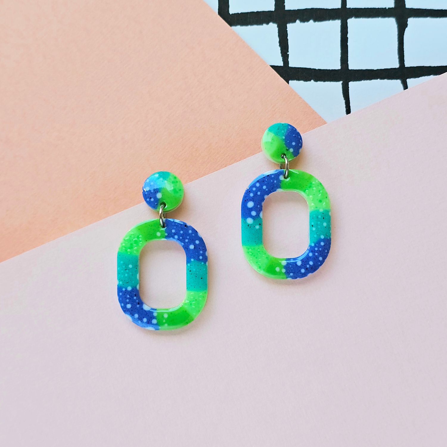 A pair of green and blue resin earrings