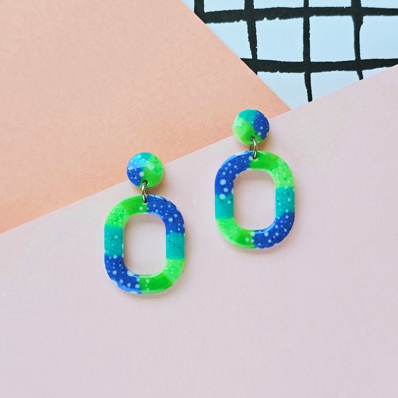 A pair of green and blue resin earrings