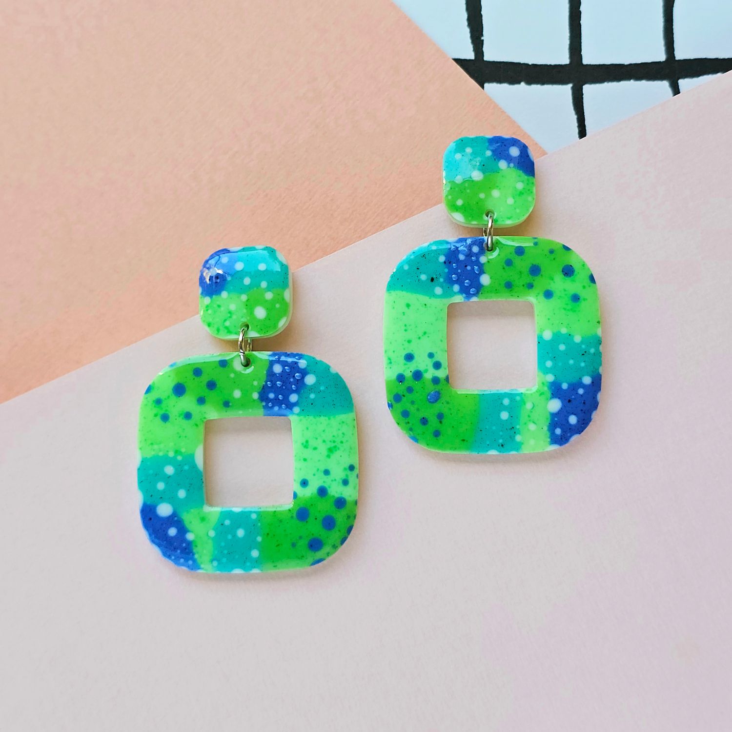 A pair of large square green and blue resin earrings