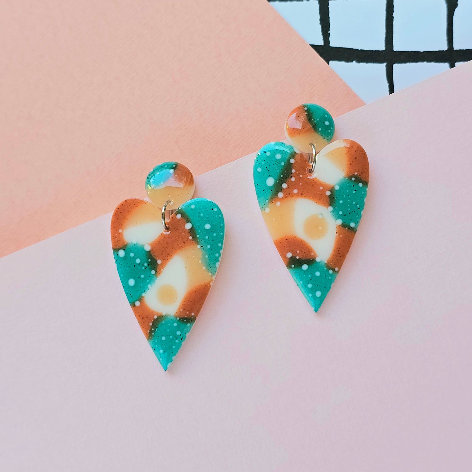 A pair of green, brown, beige heart resin earrings