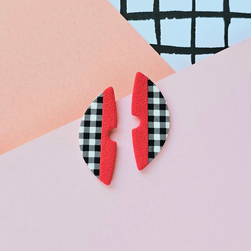 A pair of red and gingham pattern semicircle polymer clay earrings