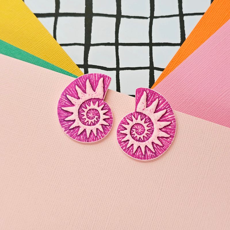 A pair of pink and white spiral faux ammonite polymer clay earrings