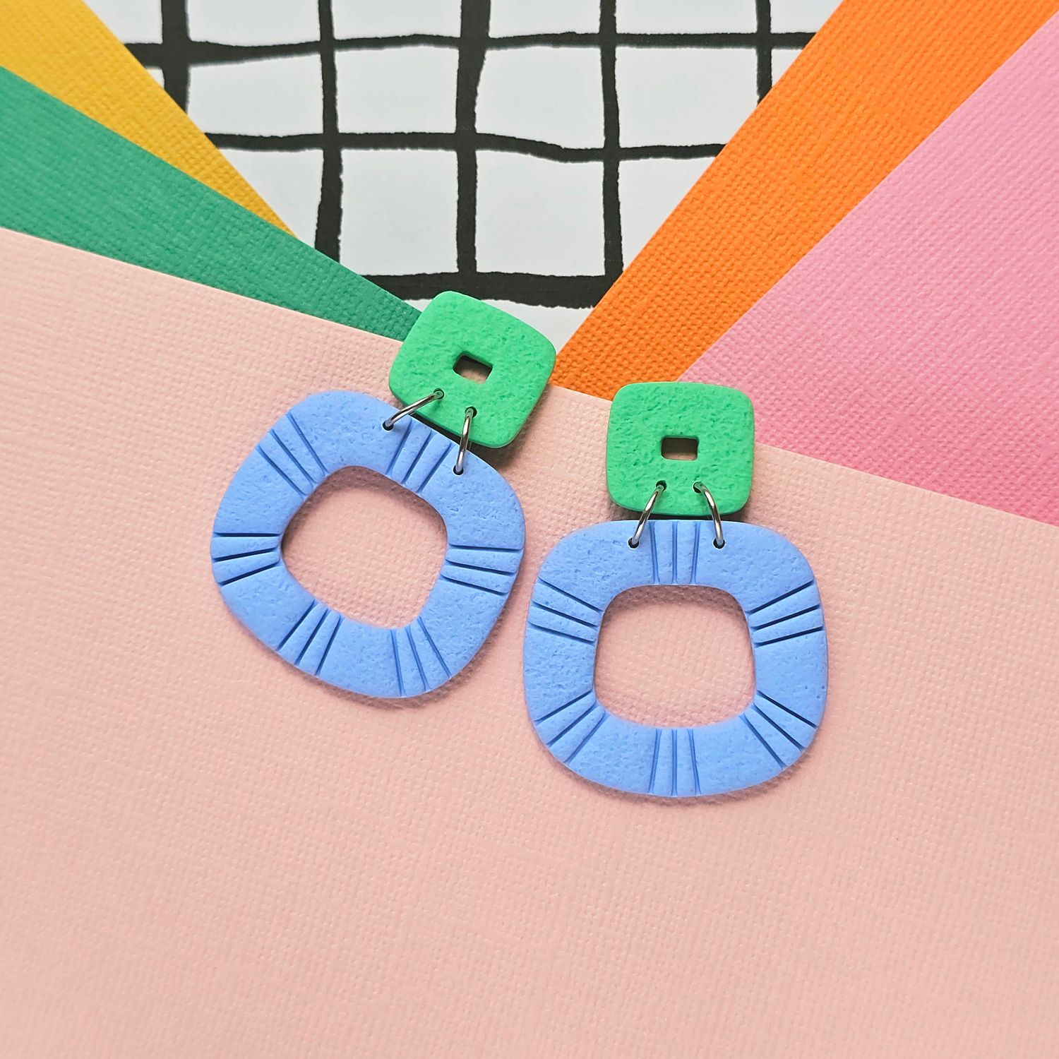 A pair of blue and green statement polymer clay earrings