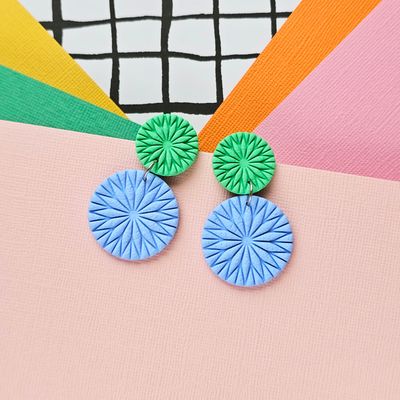 A pair of green and blue textured round polymer clay earrings