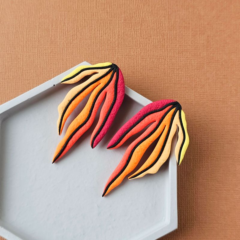 A pair of red, orange, yellow gradient leaf polymer clay long studs