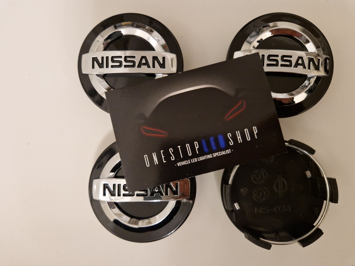 4 X Nissan black 60mm Alloy wheel center hub caps