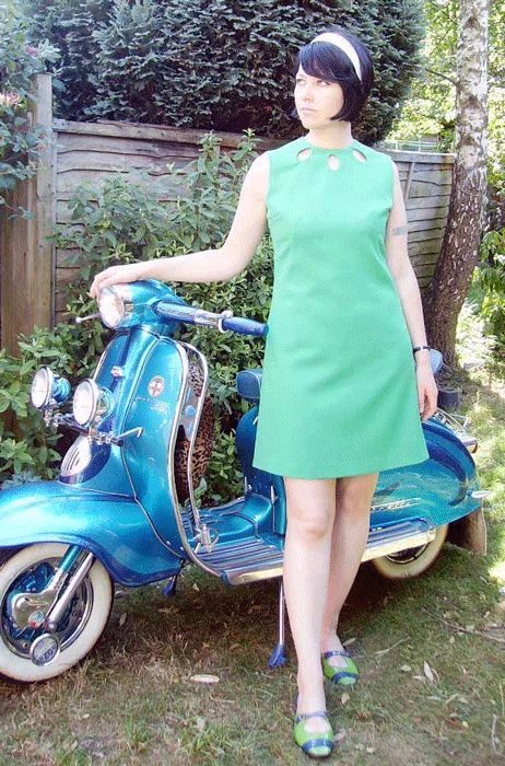 1960s dress, 60s dress, 1960s fashion, mod girl wearing a green 1960s  A-line dress , with 3 hole keyhole neckliine standing by a vintage Lambretta scooter