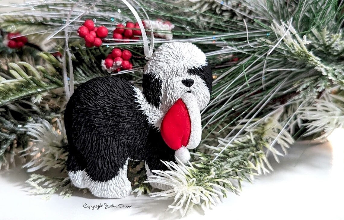 Black and White Old English Sheepdog Standing With Santa Hat In Mouth | Hand Painted Christmas Ornament & Decorative Magnet