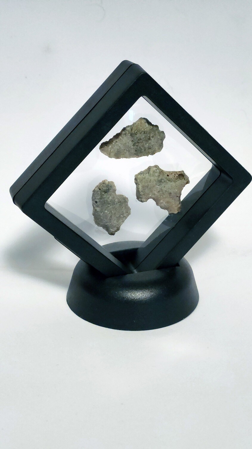 3 pieces of Trinitite in a black 3D frame
