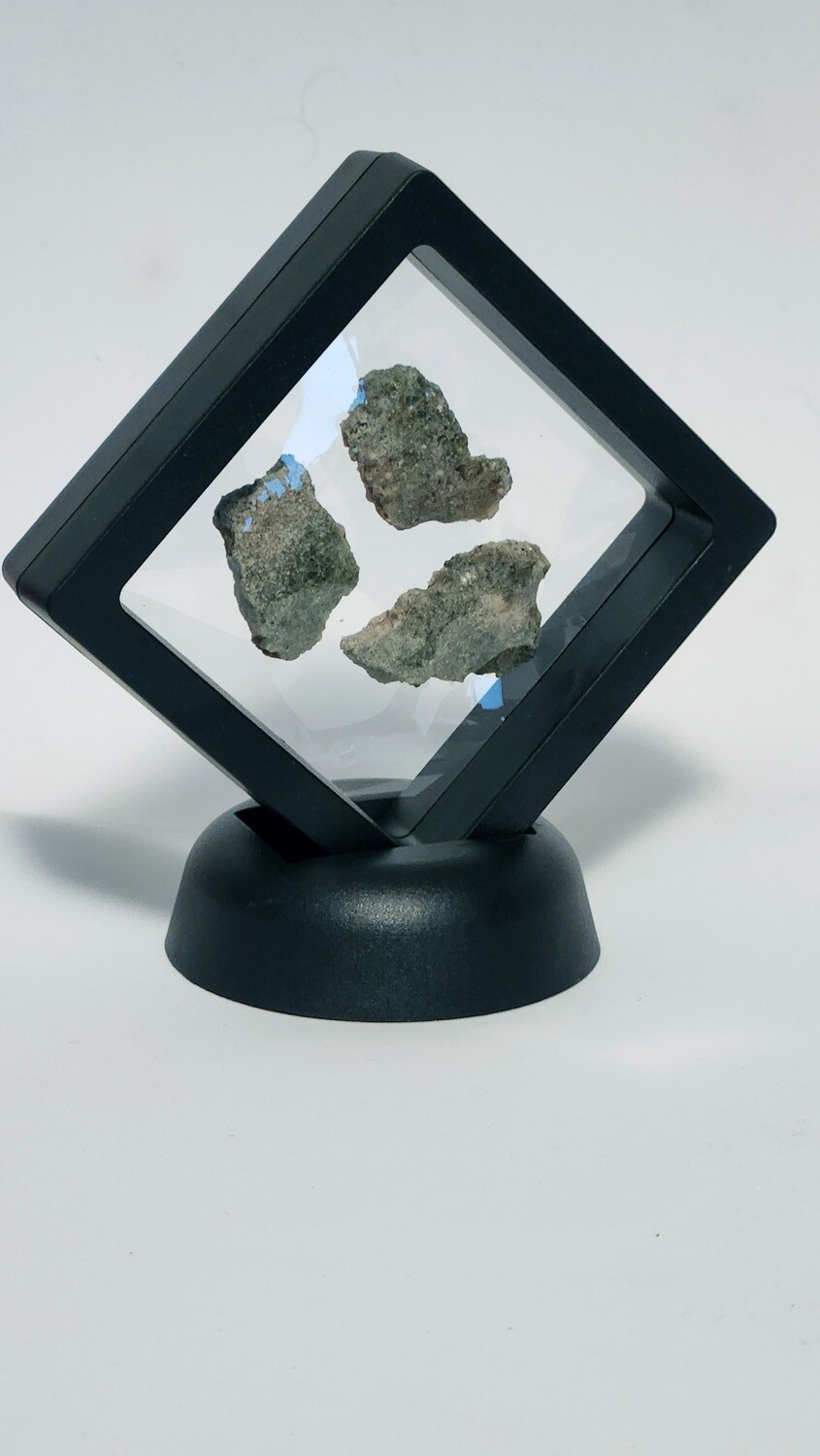 3 pieces of Trinitite in a black 3D frame