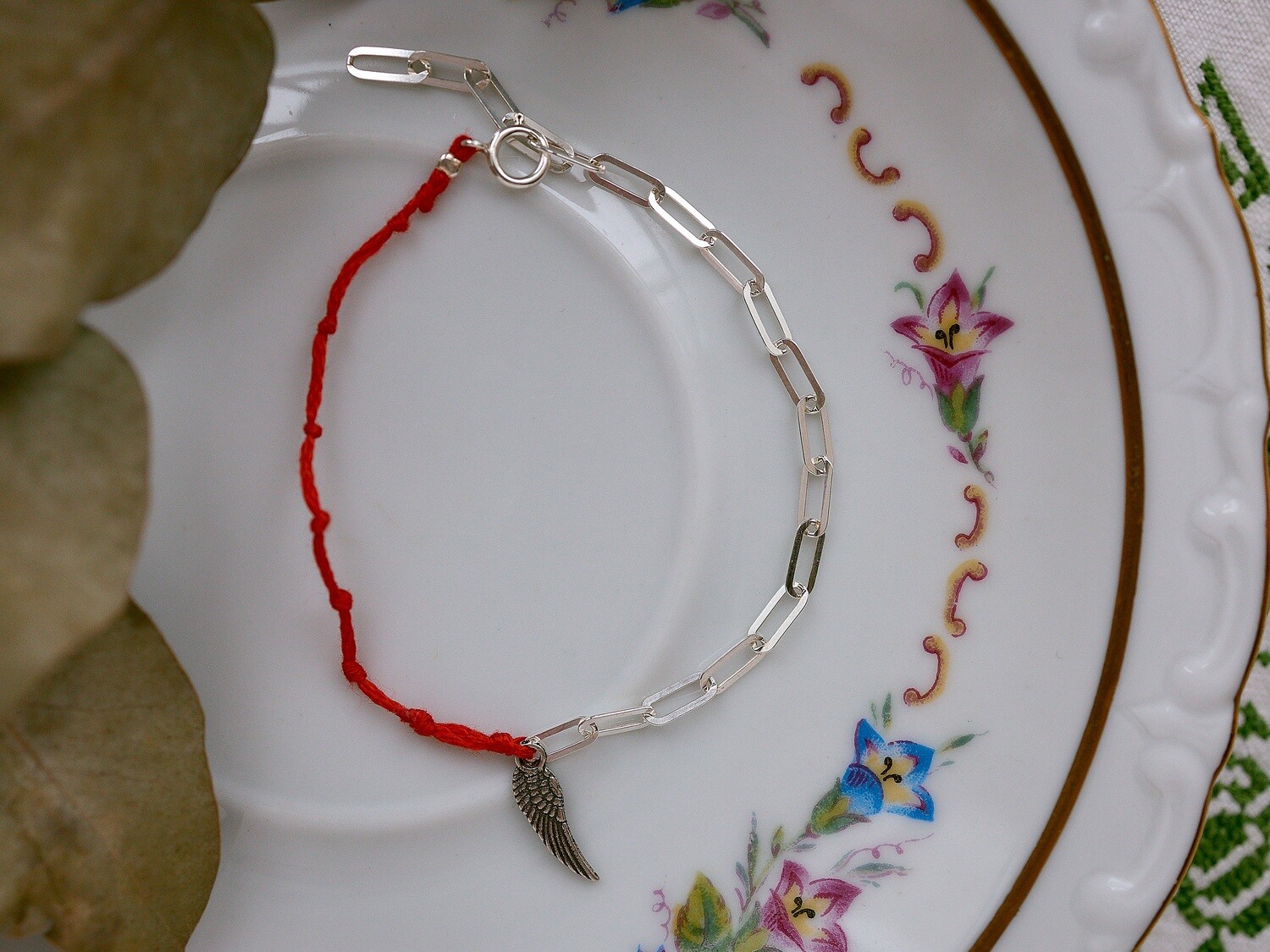 Silver bracelet with a wing charm