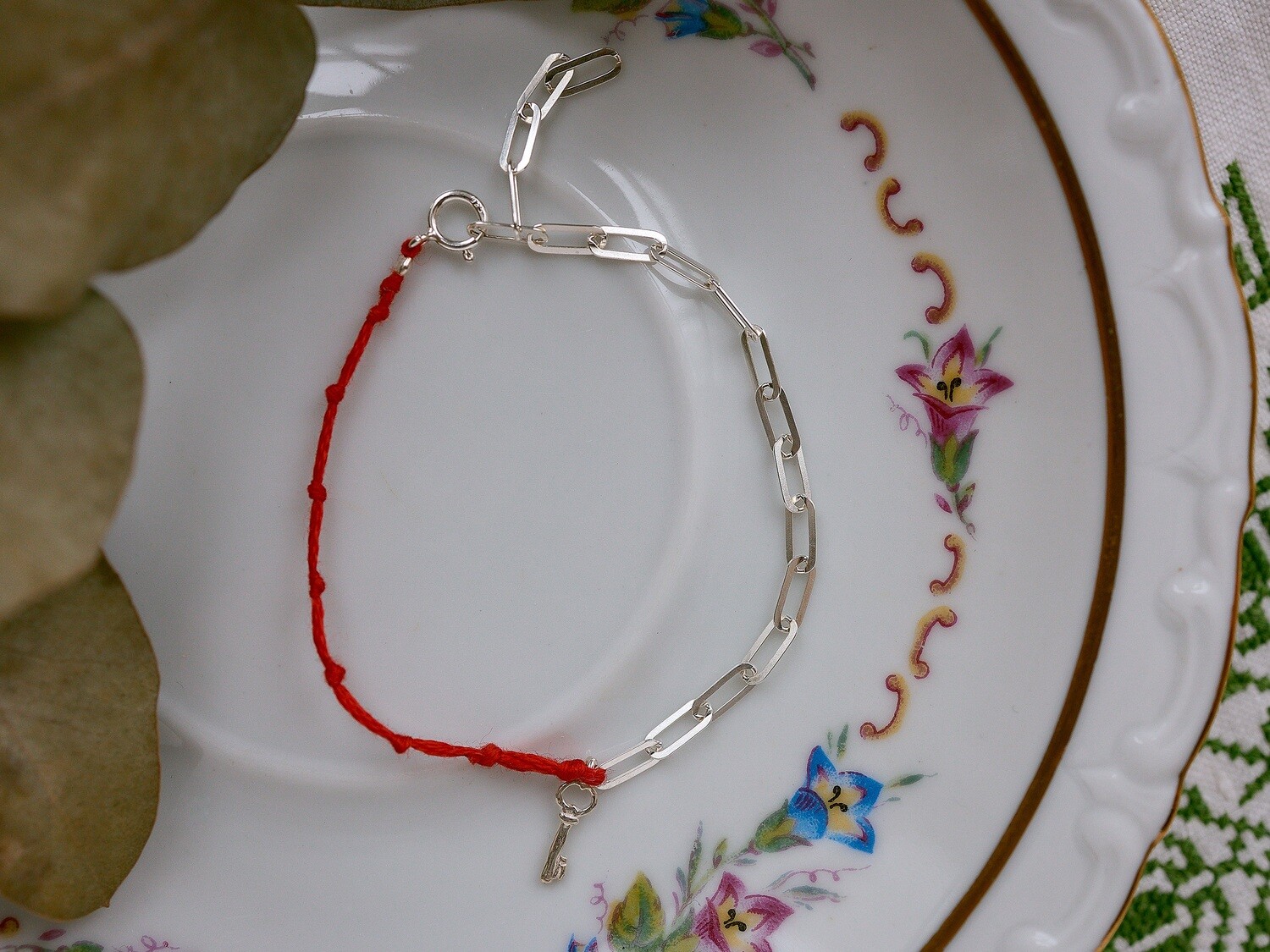 A silver bracelet with a key charm
