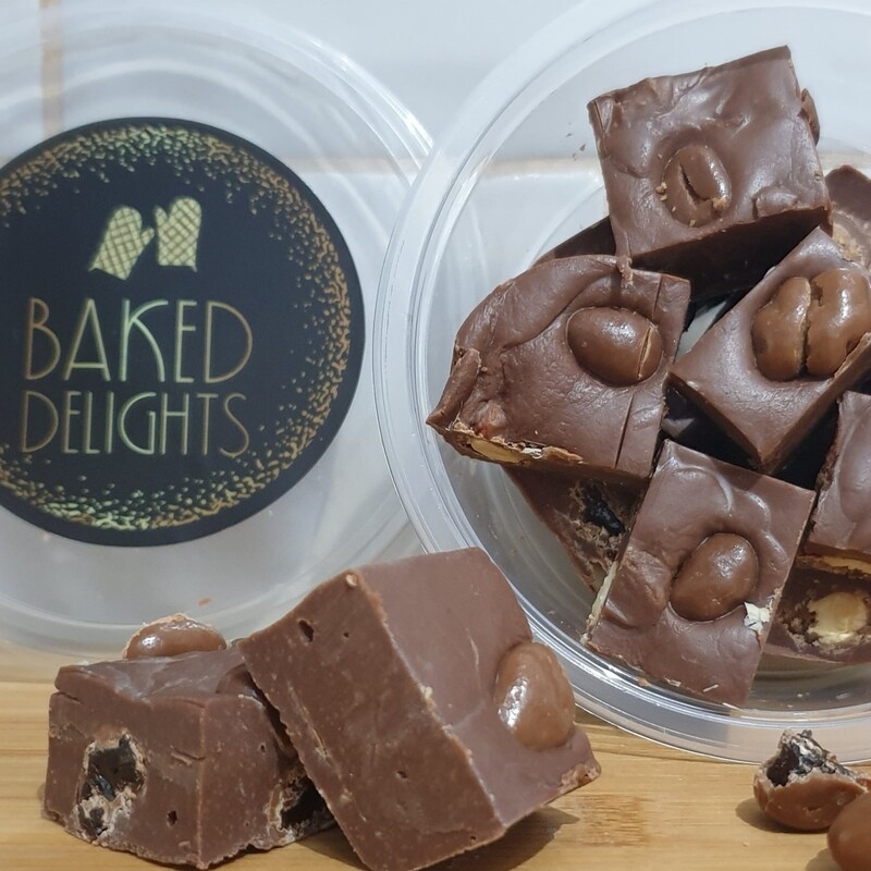 homemade milk chocolate fudge with chocolate coated nuts and rasins served in a tubb with lid