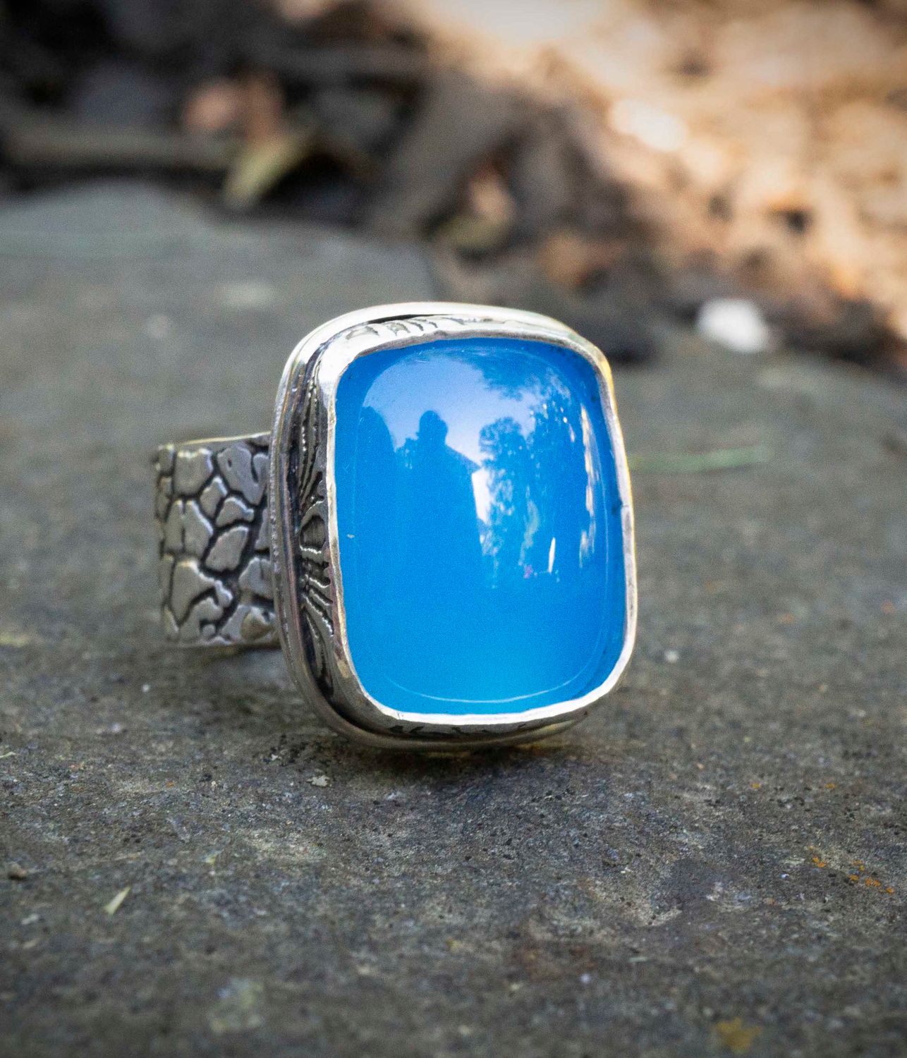 Made in the Honey Bee Metals studio, this is our one of a kind Blue Chalcedony ring, size 6.5.  The electric blue chalcedony gemstone is 18mm x 14 mm.  The ring band is all sterling silver and is textured and oxidized.